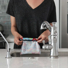 Rinsing snack bag in sink