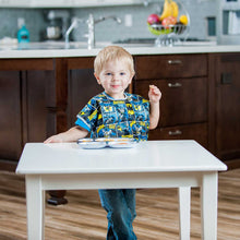 Boy standing at table in Batman Junior Bib with melamine plate