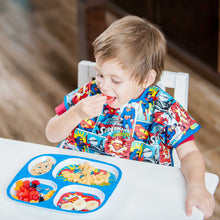Boy at table in Superman Junior Bib with melamine plate