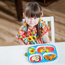 girl sitting at table in Wonder Woman Junior Bib with melamine plate